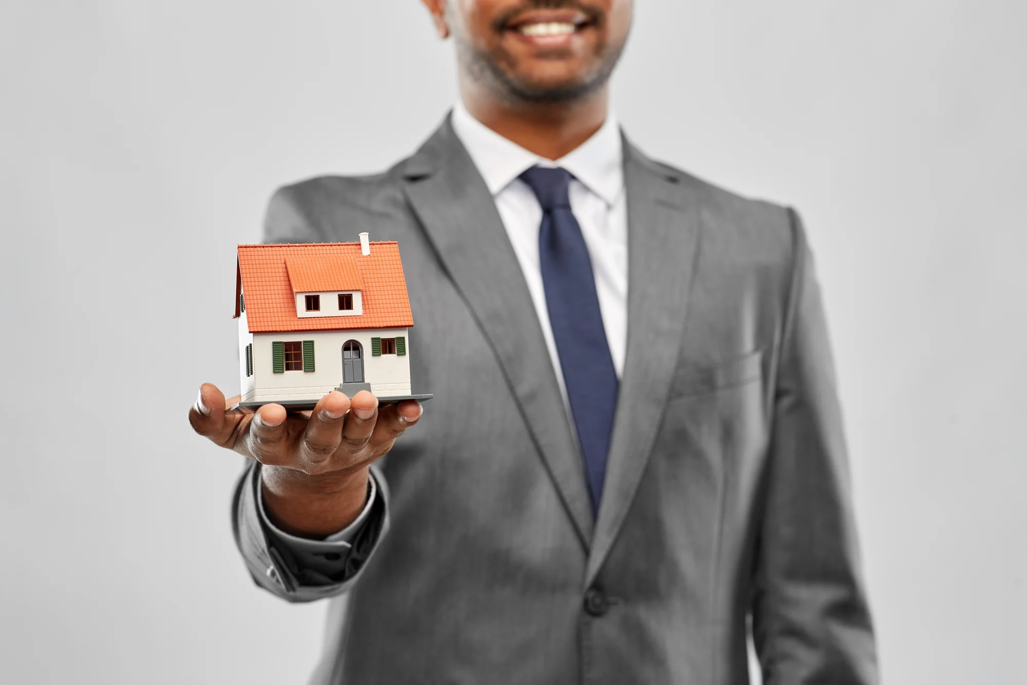 Property professional with model house - CrestCare